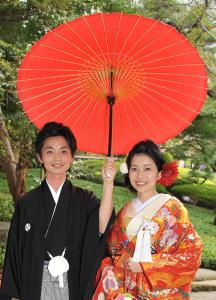 a man and a woman holding a red umbrella at Great Access to Shibuya/Shinjuku-Gracias Shibuya in Tokyo