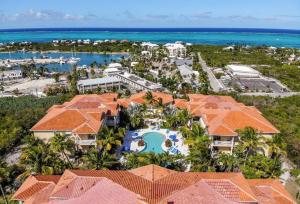 an aerial view of a resort with a pool and the ocean at Shore to Please - Large Studio Condo in Turtle Cove