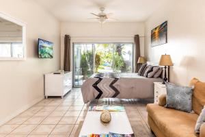 a living room with a bed and a couch at Shore to Please - Large Studio Condo in Turtle Cove