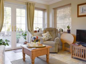 a living room with a couch and a table at The But N Ben - 28139 in Dunkeld