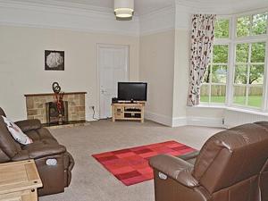 a living room with a couch and a television at Silverdale Apartment in Lindale