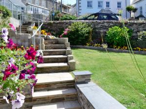 a garden with stairs and flowers in a yard at Atlantic House - 27665 in Port Isaac