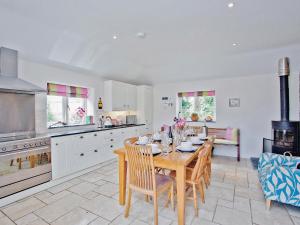 a kitchen and dining room with a table and chairs at The Mill House-tt3 in Warleggan