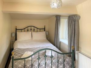 a bedroom with a bed and a window at Riverside Cottage in Horton in Ribblesdale