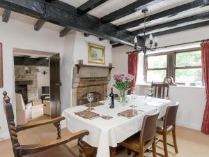 a dining room with a white table and chairs at Lillegarth in Bradwell