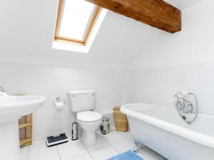 a bathroom with a toilet and a sink and a bath tub at Lillegarth in Bradwell