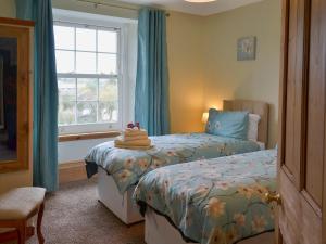 a bedroom with a bed and a window at North Coombe Farm in Upton