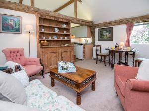 Pheasants Hill Old Byre في Hambleden: غرفة معيشة مع أريكة وطاولة