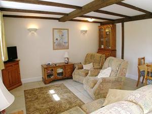 a living room with a couch and chairs and a table at Jemima Cottage in Saint Martins Green