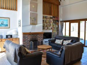 a living room with two couches and a fireplace at The Barn - 19202 in Compton