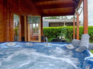 a hot tub in the backyard of a house at Ty Pren in Dyffryn