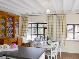 a kitchen and dining room with a table and chairs at Bwthyn in New Quay