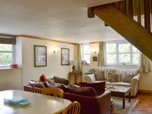 a living room with a couch and a table at Eryri in Caeathro