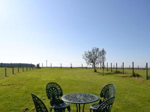 a table and chairs sitting in a field at Iona Cottage in Clarencefield