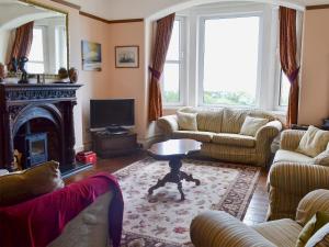 a living room with couches and a fire place at Rons House in Broadstairs