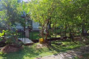 a swing set in a yard with a tree at Sumith Villa in Weligama
