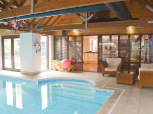 a swimming pool in a house with a room with at Burfields Barn in Rickinghall