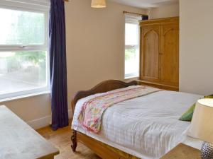 a bedroom with a bed and a window at Sea Folly in Brightlingsea