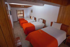 Postel nebo postele na pokoji v ubytování Centenario Inn