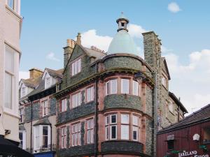 an old brick building with a turret on a street at Bag End in Keswick