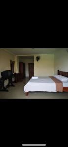 a bedroom with two beds and a desk and a piano at We Residence Studio in Pattaya Central