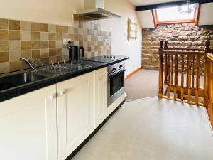 a kitchen with a sink and a stove at Seran Gypsy in Hartoft End