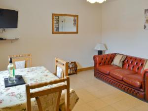 a living room with a couch and a table at Swallow in Flamborough