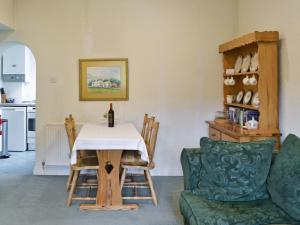 a living room with a table with a wine bottle on it at Scafell Apartment in Ambleside
