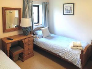 a bedroom with a bed and a dresser with a mirror at Chapman House in Parkham