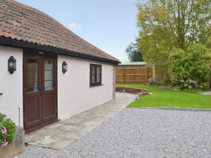 a detached house with a garage and a driveway at Bluebell Cottage in Nether Stowey
