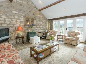 a living room with a stone wall at Bickley School Annexe in Broxa