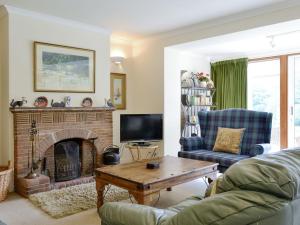 a living room with a couch and a fireplace at Lairds Cast in Banchory