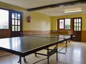 a ping pong table in the middle of a room at Birch Cottage in Cote