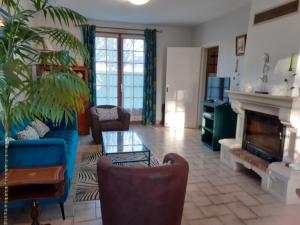 sala de estar con sofá azul y chimenea en Gîte Azay-le-Rideau, 3 pièces, 4 personnes - FR-1-381-279, en Azay-le-Rideau