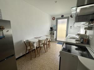 een keuken met een tafel en stoelen in een kamer bij Maison Port-Vendres, 3 pièces, 4 personnes - FR-1-309-203 in Port-Vendres