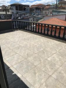 a balcony with a tile floor and a railing at Hotel São José in Ponta Grossa