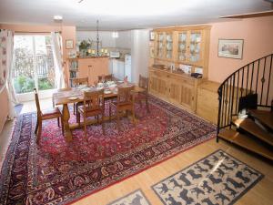 a kitchen and dining room with a table and chairs at Cherry Tree Cottage in Bovey Tracey
