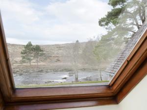 a window with a view of a river at Birch Cottage in Glenrossal