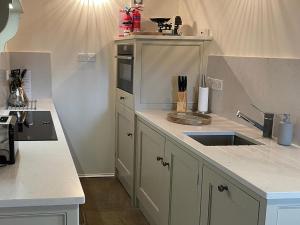 a kitchen with a sink and a counter top at The Chapel in Kilnsey