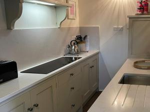 a kitchen with a sink and a counter top at The Chapel in Kilnsey
