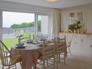 a dining room with a table with wine glasses on it at Tamar Ten in Gunnislake