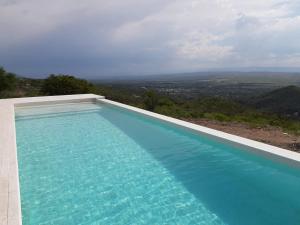a swimming pool with a view of the mountains at Loft en Rincon de la Cumbre in La Cumbre