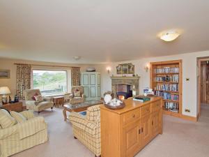 a living room with a couch and a fireplace at Rubha Lodge in Shieldaig