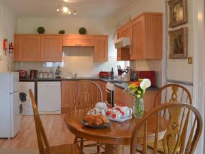 a kitchen with a table with a plate of food on it at Caradon Apt - Cv14 in Saint Cleer