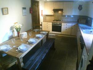 a kitchen with a table with plates on it at Cider Cottage in Hawkchurch