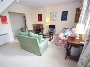 a living room with two chairs and a couch at Pepper Pot Cottage in Compton