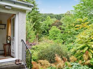 a balcony of a house with a view of a forest at Tigh Nan Allt in Dull