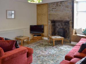 a living room with two couches and a fireplace at Manor House in Uny Lelant
