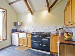 a kitchen with a blue stove top oven at Manor House in Uny Lelant