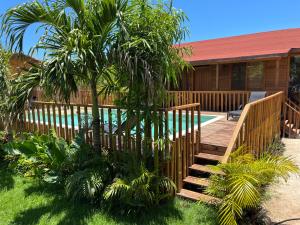 a wooden staircase leading to a house with a swimming pool at Anicca Aldea in Holbox Island